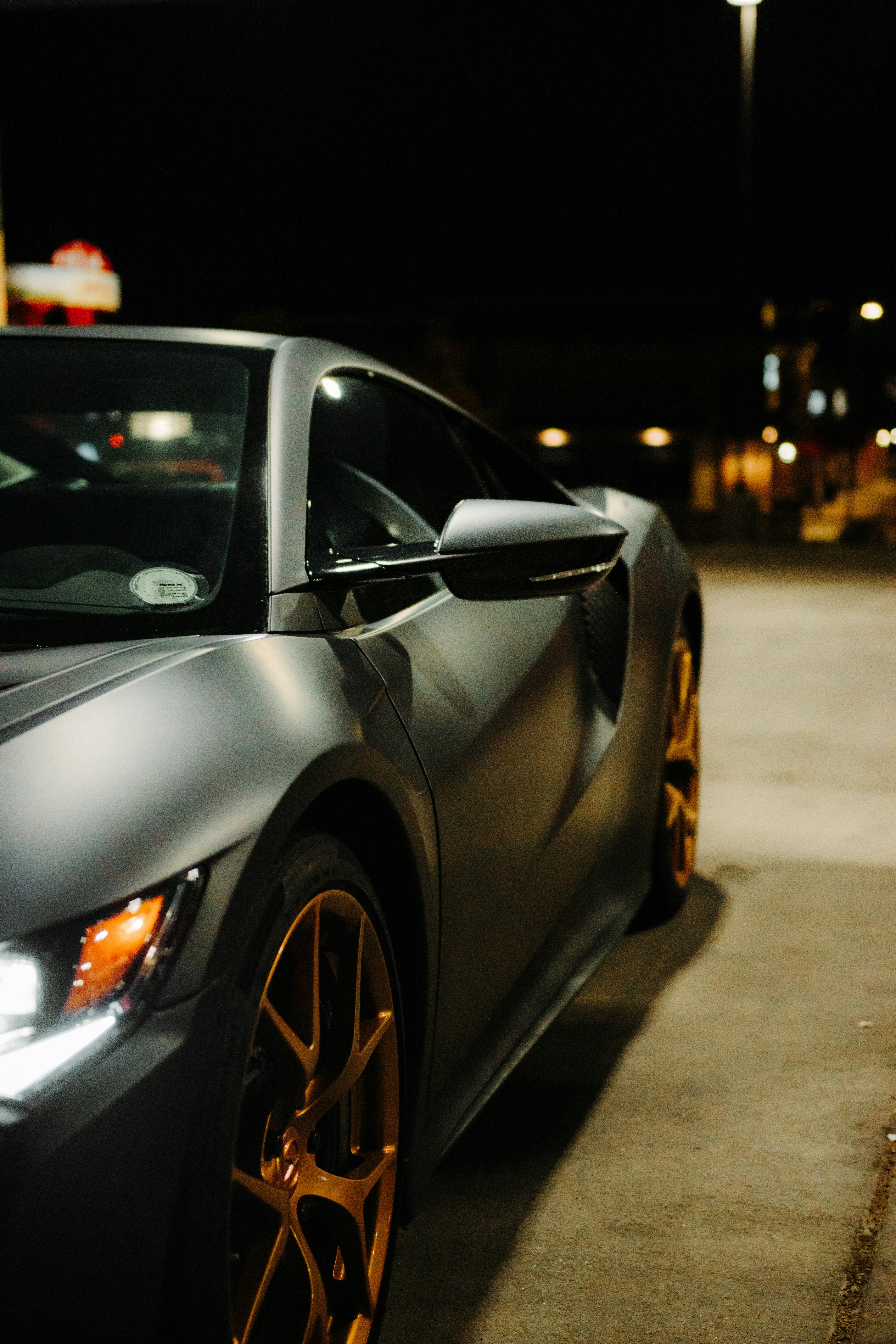 silver porsche 911 parked on street during night time